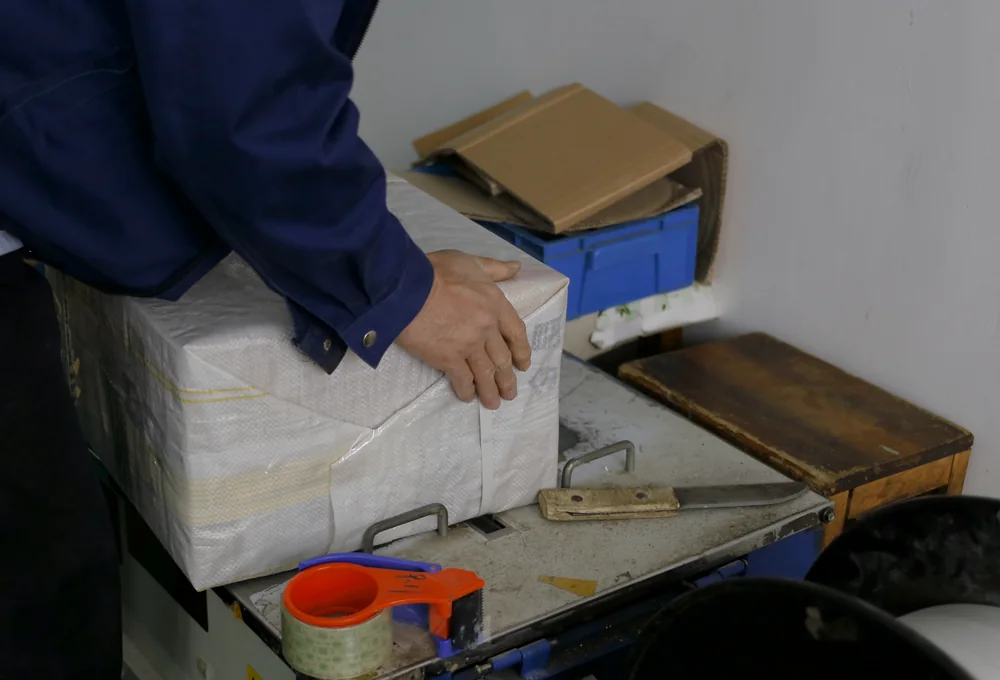 Kailing staff checking and packing a product shipment